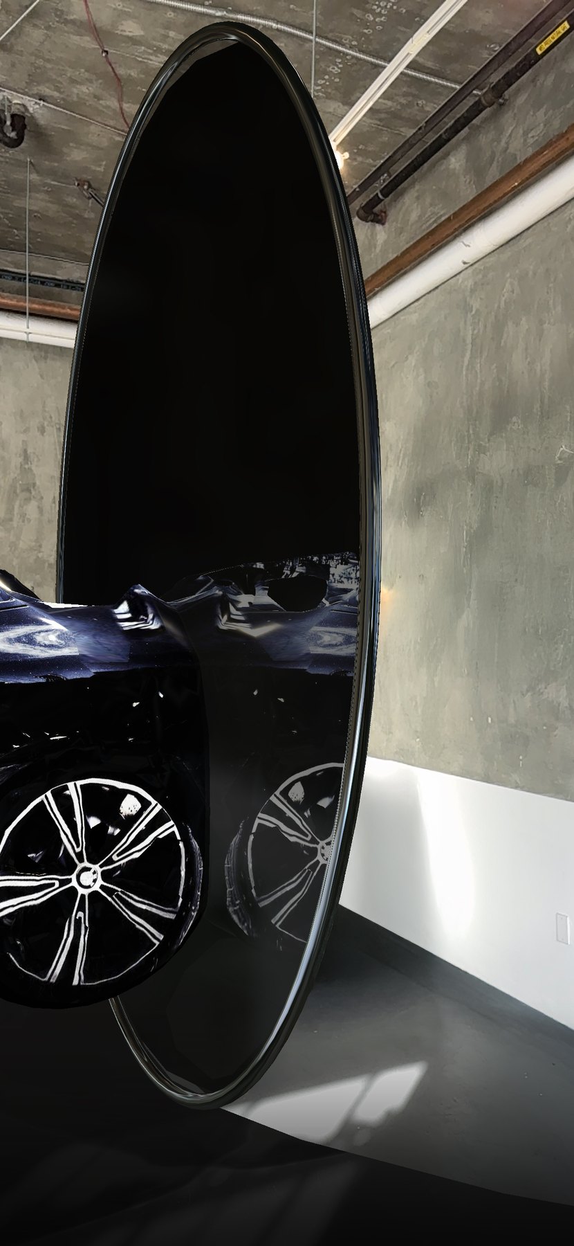 An oval mirror in the gallery reflects the crash of Encounter/Reflection.